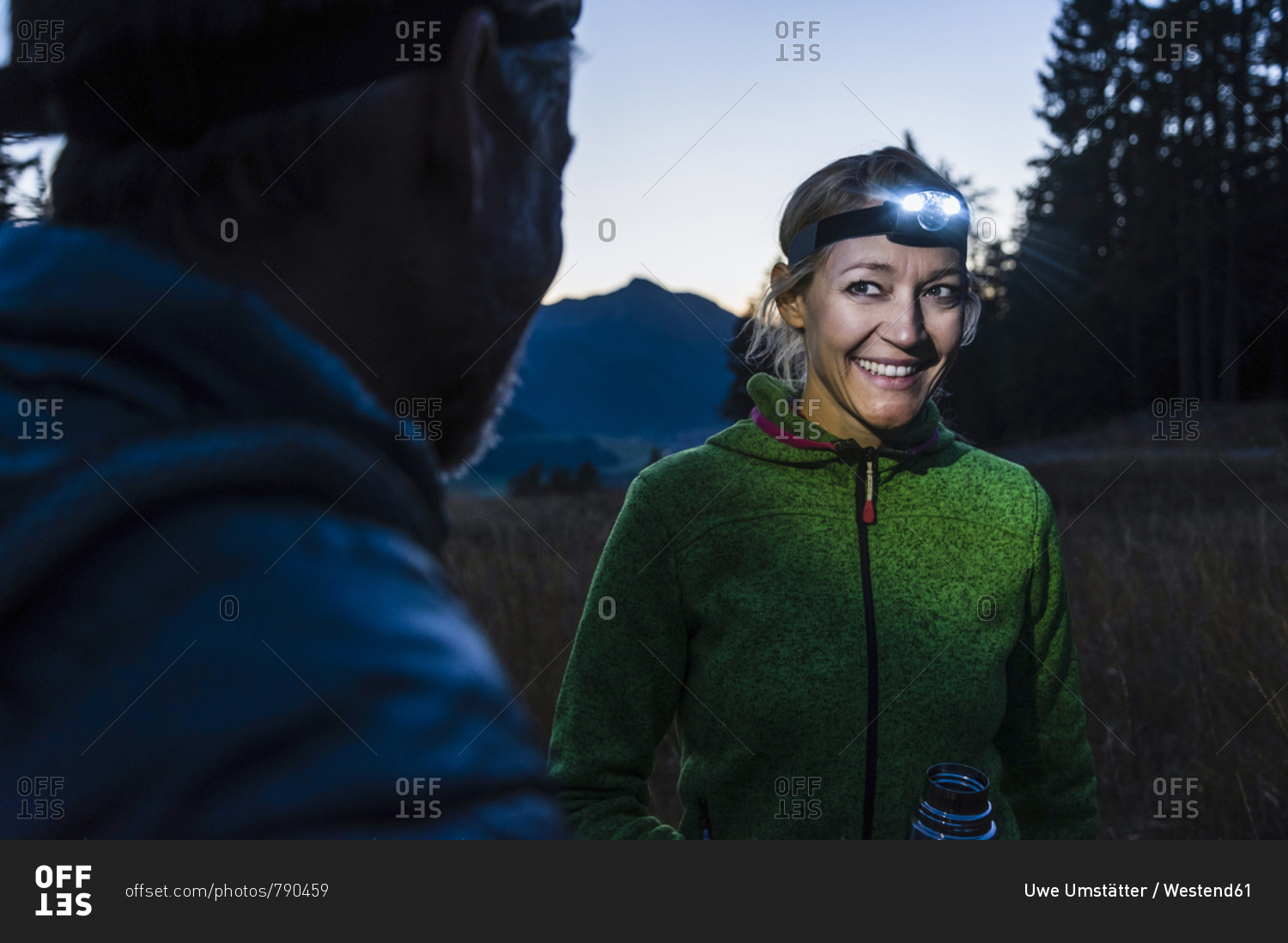 Couple hiking at night- wearing head lamps