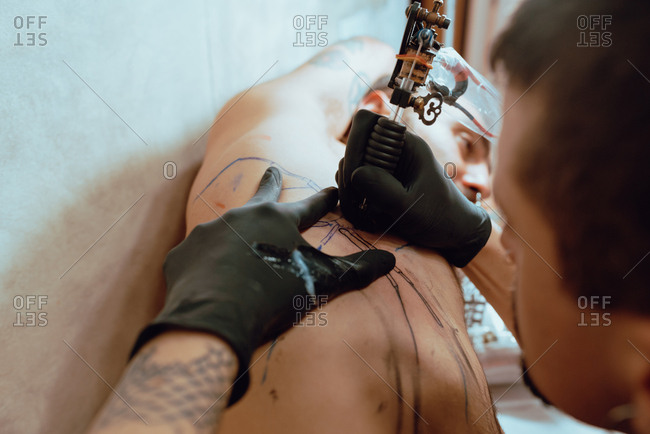 Stylish woman making tattoo