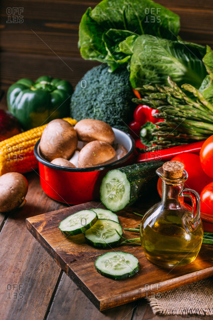 Wooden box with fresh multicolored vegetables and herbs on wooden rustic floor