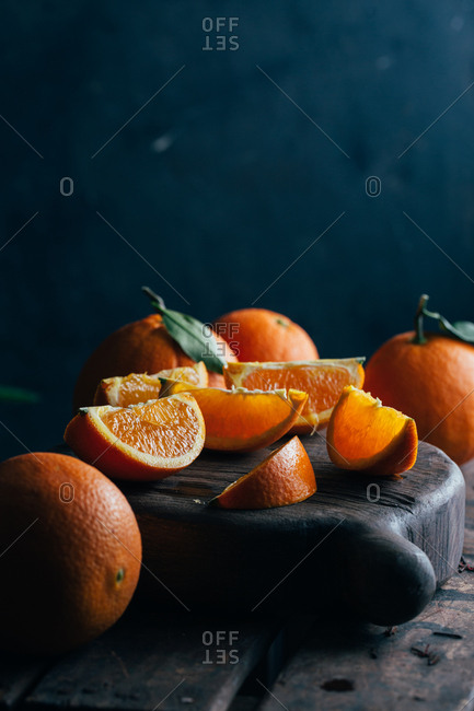 Fresh cut oranges on dark moody background
