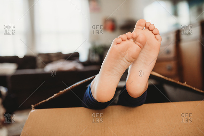 Bare Feet Of A Little Girl Hiding In A Box Stock Photo Offset