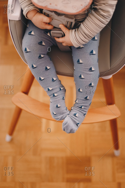 Baby sitting in a feeding chair