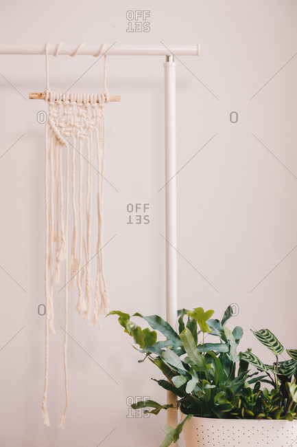 Homemade yellow macrame hanged in a living room space.