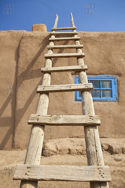 Wooden Ladder Against an Adobe Building