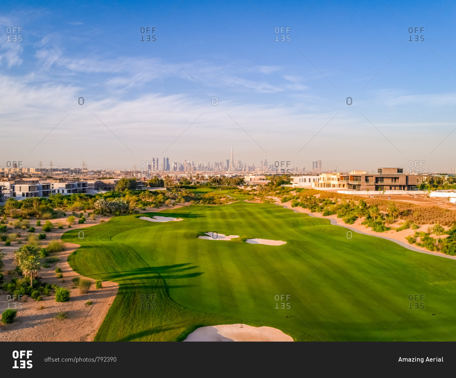 Aerial view of luxury golf club with Dubai at the background, U.A.E