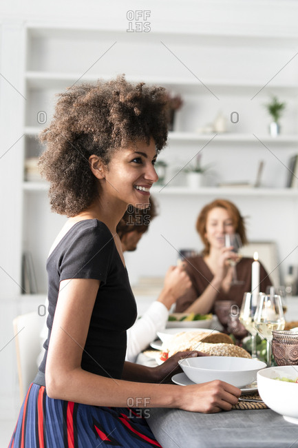 Friends having fun at a dinner party- enjoying eating together