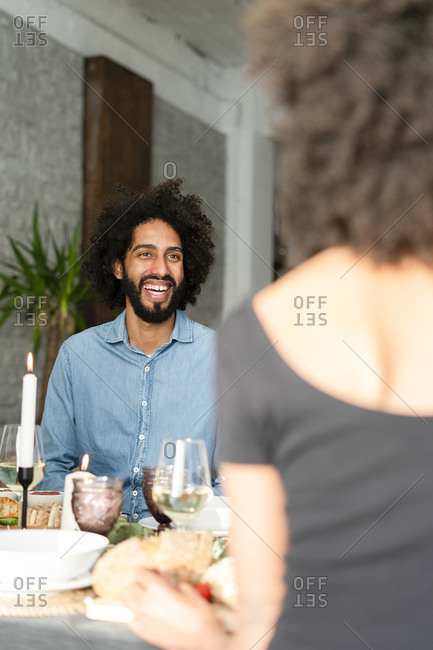 Friends having fun at a dinner party- enjoying eating together