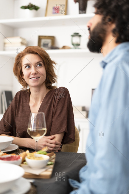 Friends having fun at a dinner party- enjoying eating together