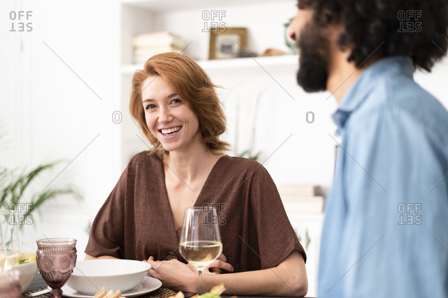 Friends having fun at a dinner party- enjoying eating together