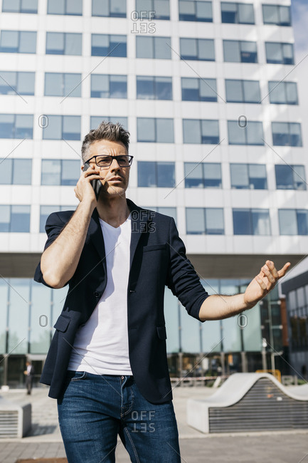 Side View Of A Handsome Young Businessman Making A Phone Call, Standing In A  Confident Pose At A Panoramic Window Of His Hotel Room Stock Photo, Picture  and Royalty Free Image. Image