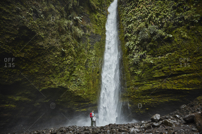 Chile- Patagonia- Osorno Volcano- mother and son standing at Las Cascadas waterfall