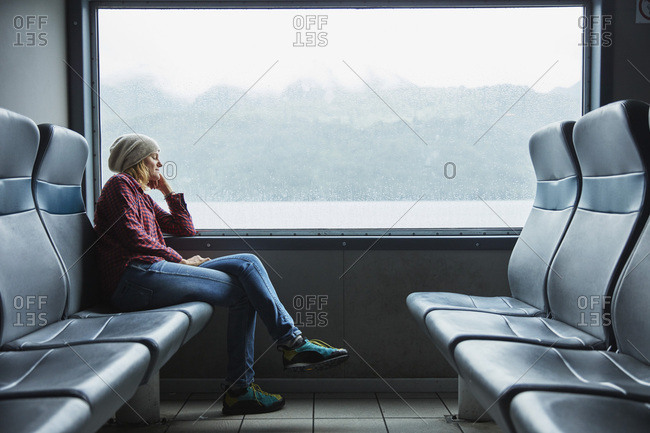 Chile- Hornopiren- woman sleeping at the window of a ferry