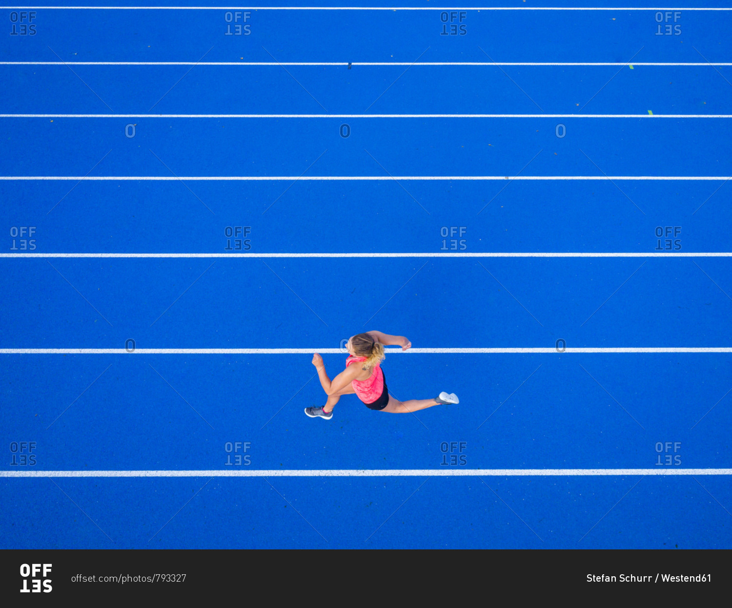 Top view of female runner on tartan track