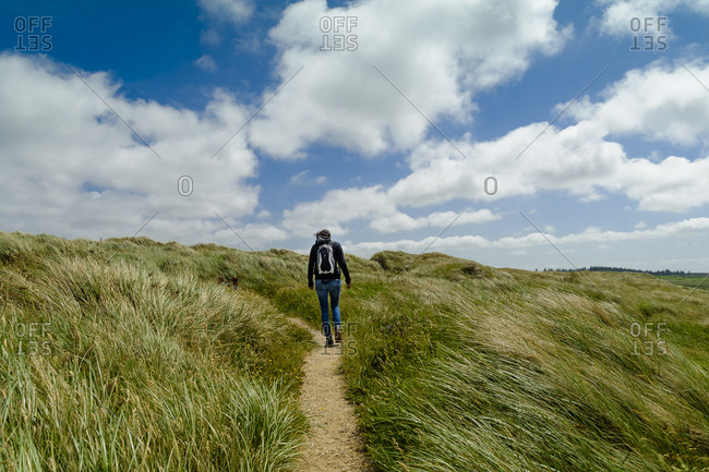 Denmark- Jutland- woman walking in dune landscape