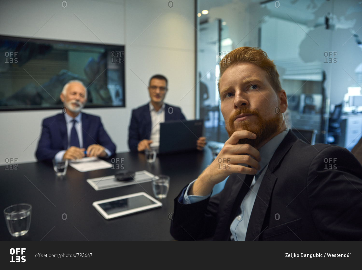 Portrait of businessman turning round in a meeting