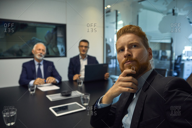 Portrait of businessman turning round in a meeting