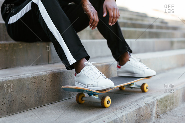 Anonymous skater sitting on stairs.