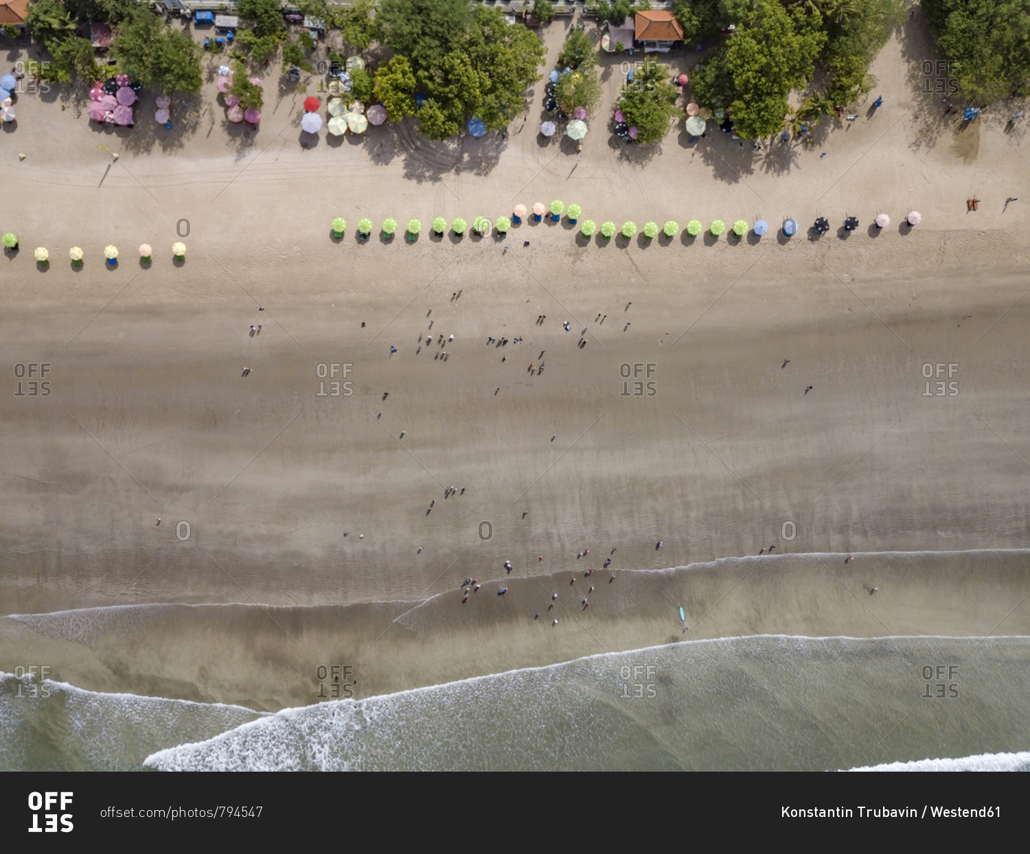 Bali- Kuta Beach- row of beach umbrellas and people on the beach- aerial view