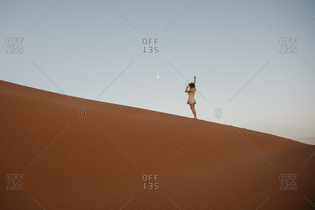 Namibia- Namib desert- Namib-Naukluft National Park- Sossusvlei- woman standing on Elim Dune at sunset