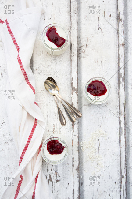 Three glasses of rice pudding with berry compote