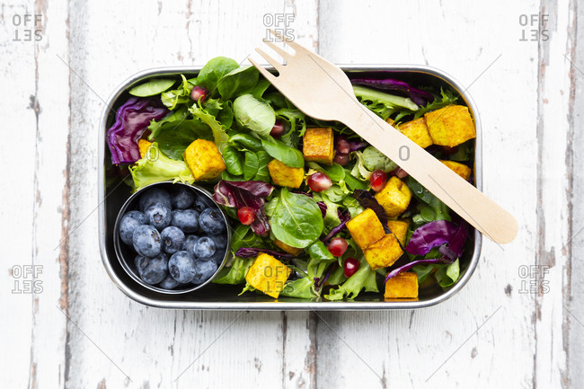 Mixed salad with roasted tofu- red cabbage- pomegranate seeds- blueberries and curcuma in lunch box