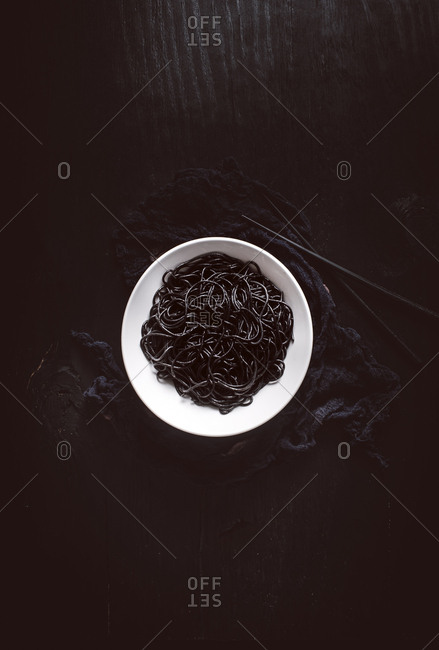 Overhead view of a bowl of squid ink pasta