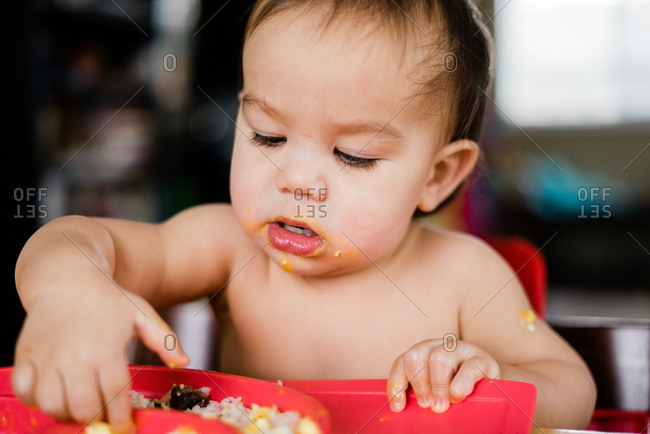 Baby making mess while eating food