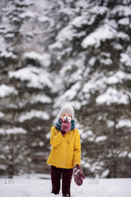 Little girl outside playing in deep snow