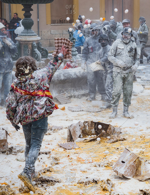 Ibi, Spain - December, 28 2018: People throwing eggs and flour at each other