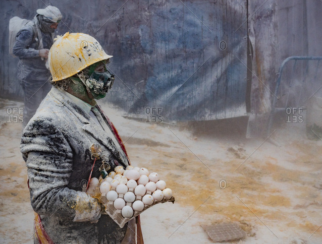 Ibi, Spain - December, 28 2018: People throwing eggs and flour at each other