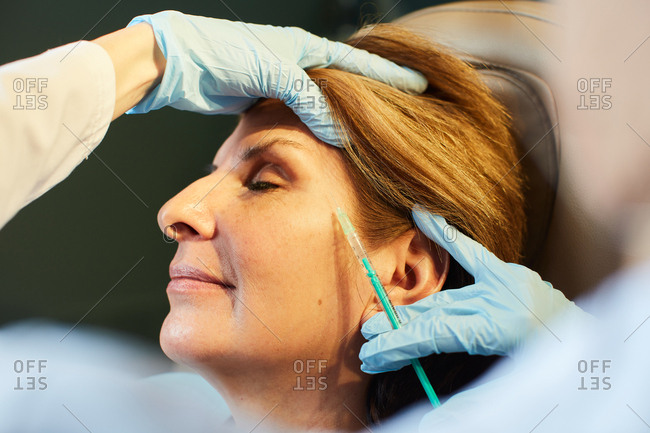 Woman getting facial injections