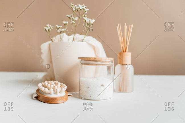 spa items on white table with pecan wall