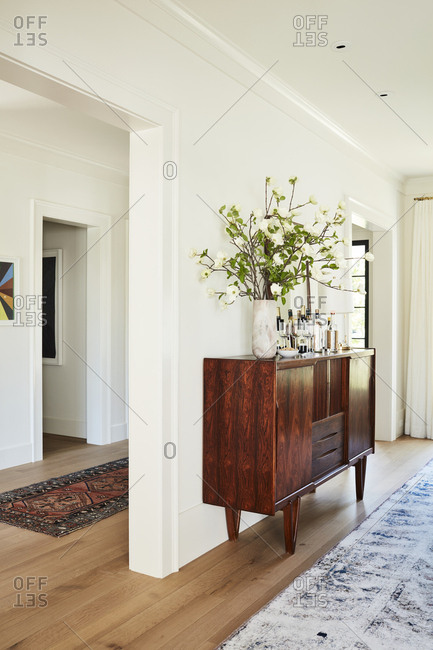 Los Angeles, California - February 14, 2015: Large wooden credenza in hallway of an upscale home