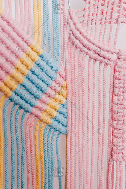 Closeup detail of multicolored macrame threads.