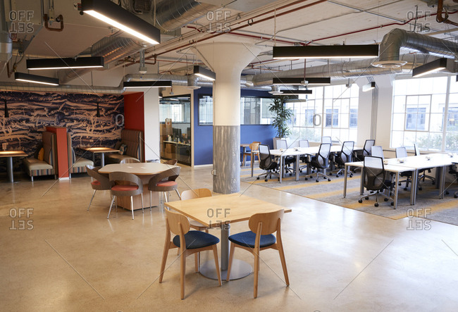 Kitchen, eating area and open plan desk workspace in a creative office