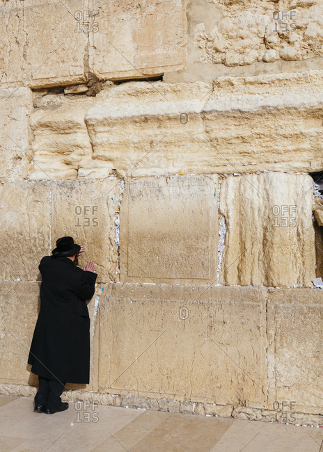 Orthodox Jewish man praying at the wailing wall known also as the western wall in the old city, Jerusalem, Israel.
