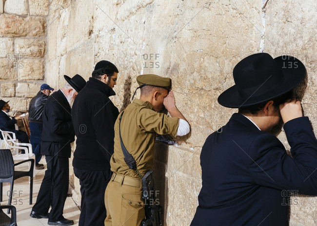 January 13, 2019: Jewish men praying at the wailing wall known also as the western wall in the old city, Jerusalem, Israel.