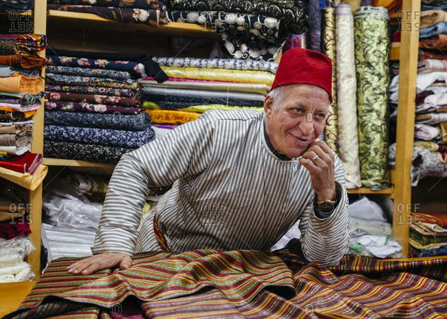 January 21, 2019: Bilal Abu Khalaf, fabric merchant in the old city, Jerusalem, Israel.