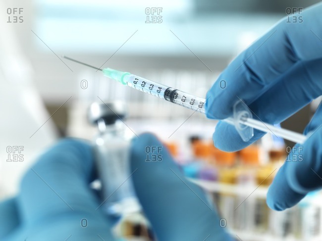 Doctor preparing a dose of medicine to give to a patient.