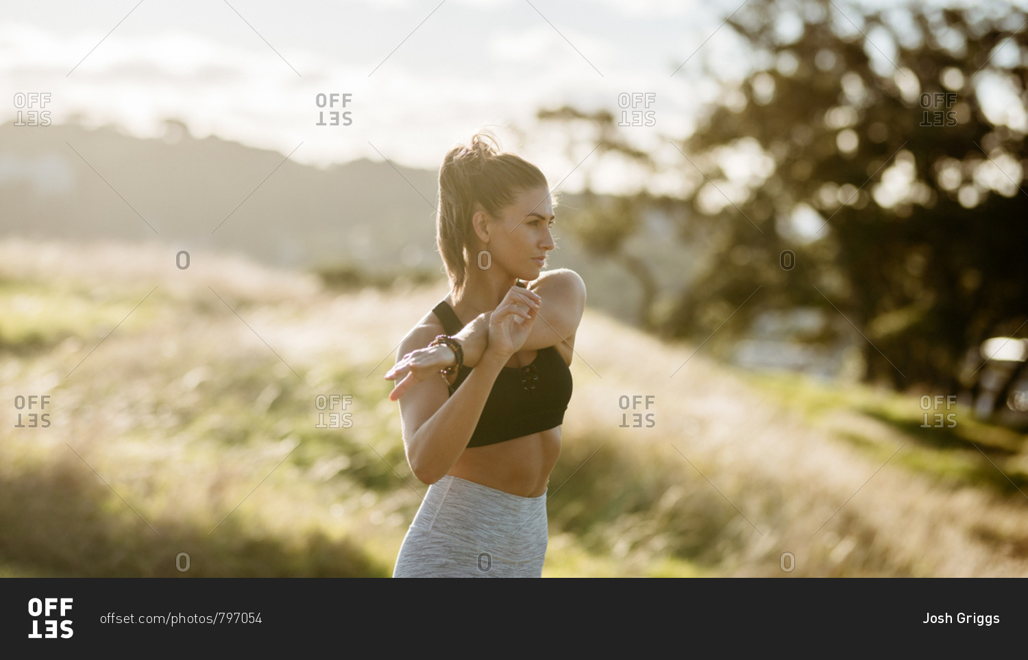 Beautiful woman stretching before workout in the countryside
