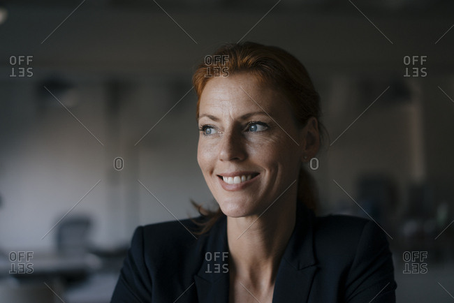 Portrait of smiling businesswoman looking sideways