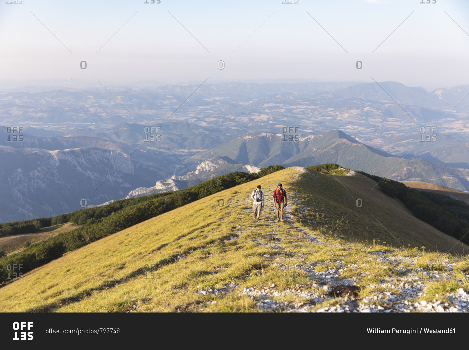 Italy- Monte Nerone- two men hiking on top of a mountain in summer