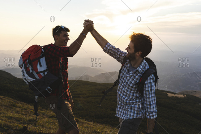 Italy- Monte Nerone- two happy and successful hikers in the mountains at sunset