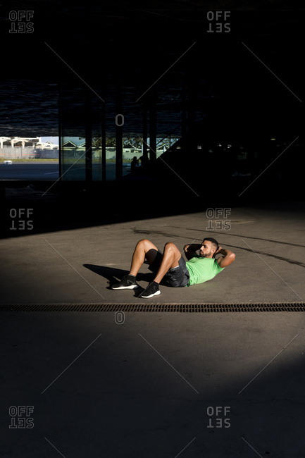 Sportive man during workout- sit-up