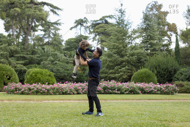 Father and son playing together in park