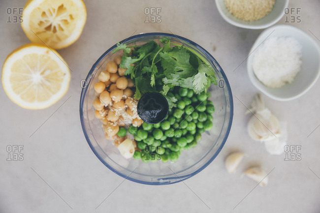 Ingredients for peas hummus- chickpeas- lemon- coriander- garlic- sesame and salt in blender