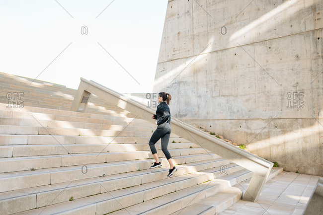 Young athlete running, warming up, climbing stairs