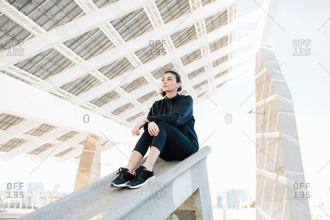 Young athlete sitting, looking into distance