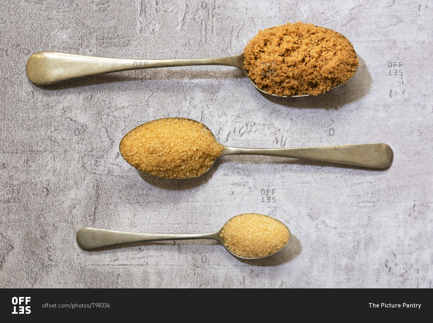 Spoonfuls of demerara, raw and brown sugar.