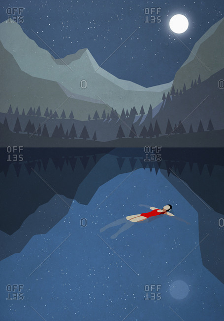 Moonlight shining over serene woman floating on back in tranquil mountain lake